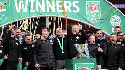 Manchester City staff celebrate with the trophy after the football team's win in the Carabao Cup Final at Wembley Stadium, London on March 1, 2020. John Walton / PA