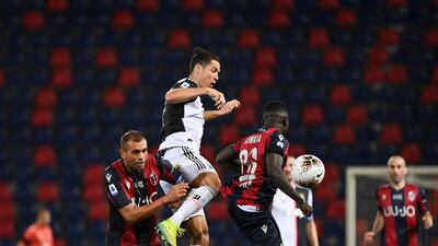 Juventus' Cristiano Ronaldo jumps for the ball against Bologna's Danilo and Musa Juwara. AP