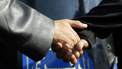 Muslim Brotherhood protesters hold hands as they face Egyptian police during a protest in 2005.