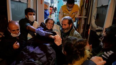 Nuriye Gulmen, a 35-year-old Turkish professor who has been on hunger strike since losing her job in a purge following last year's failed coup, leaves an ambulance upon arrival at her home in Ankara on December 2, 2017. Reuters