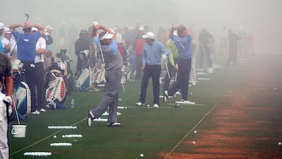 DUBAI, UNITED ARAB EMIRATES - JANUARY 30: Colin Montgomerie of Scotland and Ernie Els of South Africa both on their follow-throughs are amongst players warming up in the fog that delayed the start by 3 three hours during the completion of the first round of the 2009 Dubai Desert Classic on the Majilis Course at the Emirates Golf Club on January 30, 2009 in Dubai, United Arab Emirates. (Photo by David Cannon/Getty Images) *** Local Caption *** GYI0056609503.jpg