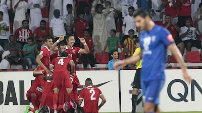 Al Ahli players celebrate the winning goal in injury time as the Dubai club gets past Al Hilal on Wednesday night in Dubai and advances to the Asian Champions League final. Jeffrey E Biteng / The National