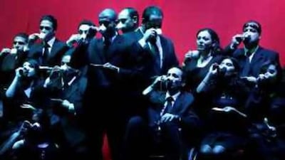 Actors drink coffee in the opening scene from the play Ahwa Sada.