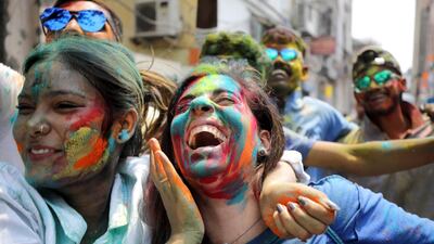 Tourists and locals apply colour dust to each other as they celebrate Holi festival in Kolkata, Eastern India. EPA