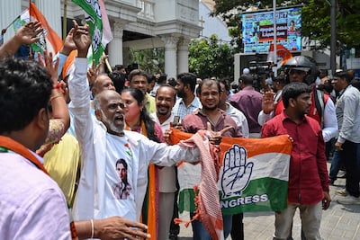 Congress supporters celebrate in front of the Karnataka Pradesh Congress Committee office in Bengaluru. AFP