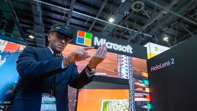 A guest uses the new Microsoft HoloLens 2 at the company's stand at Gitex Technology Week in Dubai on Tuesday. Leslie Pableo / The National