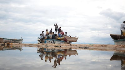 Fishermen board a boat in readiness of a long night of fishing on Lake Malawi’s shore about 200km out of the commercial capital Blantyre, Malawi. Many people earn their living by either catching or selling fish from the lake. Aaron Ufumeli / EPA