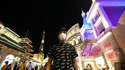 A man wearing a protective mask following an outbreak of coronavirus walks at Global Village in Dubai. REUTERS