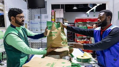 Delivery riders collect groceries ordered on the Careem app from the shop, which serves a 3km radius in Al Barsha