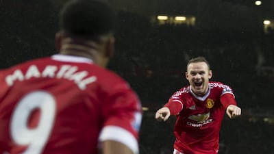 Wayne Rooney celebrates with Anthony Martial after scoring Manchester United’s winning goal. Jon Super / AP Photo