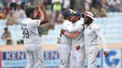 India spinner Ravichandran Ashwin, left, celebrates with teammates after the dismissal of South Africa's Kagiso Rabada. AP
