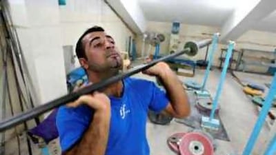 Sawara Mohammad, Iraq's only weightlifting competitor who was hoping to compete in this year's Beijing Olympics, trains at a gym in Arbil, north of Baghdad.