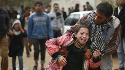 Daughters, front and back left, of 32-year-old Palestinian man Fadel Mohammed Halawa, whom medics said was shot dead by Israeli forces, cry during his funeral in Gaza City on November 23, 2014. Suhaib Salem / Reuters