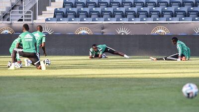 Nigeria players stretch on Monday before their World Cup training session. Nicholas Kamm / AFP / June 2, 2014