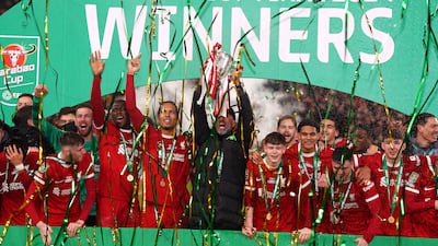 Liverpool manager Jurgen Klopp lifts the League Cup trophy at Wembley Stadium. PA