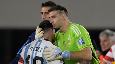 Argentina goalkeeper Emiliano Martinez kisses Lionel Messi's head at the final whistle in a 1-0 win over Paraguay. AFP
