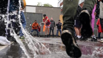 Fans play cricket behind the stands at Old Trafford. PA