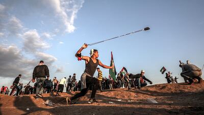 A Palestinian protester hurls stones at Israeli troops with his sling during clashes after Friday protests near the border between Israel and Gaza, 21 December 2018. EPA