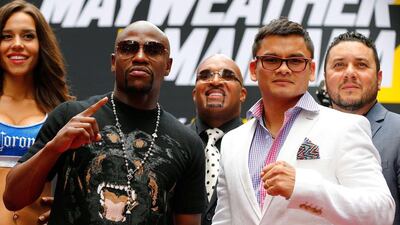Marcos Maidana, right, and Floyd Mayweather Jr pose for a photo during a news conference at the Pedestrian Walk in Times Square on July 14, 2014 in New York City. Floyd Mayweather Jr. and Marcos Maidana are scheduled to fight September 13, 2014 at the MGM Grand in Las Vegas. Mike Stobe/Getty Images