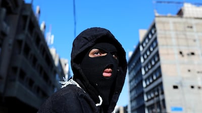 A masked demonstrator is seen during ongoing anti-government protests. Reuters