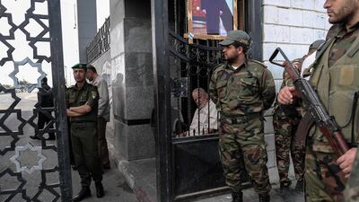 Palestinian security forces loyal to Hamas (right) stand guard outside the Rafah border crossing with Egypt, as security forces loyal to the Palestinian Authority stand guard inside (left), in the southern Gaza Strip on November 18, 2017. Said Khatib / AFP