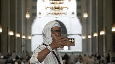 A pilgrim takes a selfie at the Grand Mosque. AP
