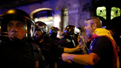 Catalan police prevent demonstrators from moving forward during a march against the unilateral declaration of independence approved earlier by the Catalan parliament in downtown Barcelona on Friday. Catalan lawmakers voted Friday to secede from Spain, shortly before Spain's Senate approved a request by the central government to take direct control of Catalonia's affairs. Manu Fernandez / AP