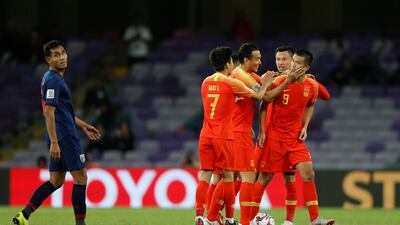 China's players celebrate after coming from behind to beat Iran and reach the Asian Cup quarter-finals. Reuters