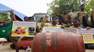 Auto rickshaw drivers hold placards and shout slogans during a protest over the shortage of liquefied petroleum gas cylinders in Bengaluru, India. EPA