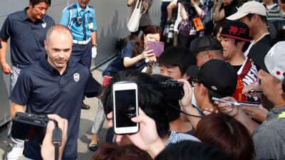 Iniesta is welcomed by fans upon arrival at Kansai International Airport. Kyodo News / AP