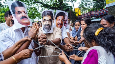 Indian National Congress party workers wear masks of Kerala film stars during a protest against the government's action over alleged sexual abuse within the industry. AFP