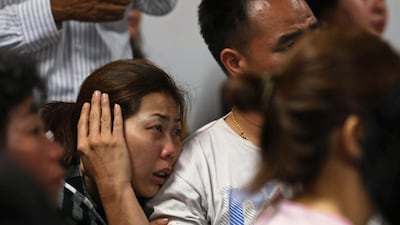 Family of passengers onboard AirAsia flight QZ8501 react at a waiting area in Juanda International Airport, Surabaya December 28, 2014. Indonesia's air force was searching for the AirAsia plane carrying 162 people that went missing on Sunday after the pilots asked to change course to avoid bad weather during a flight from the Indonesian city of Surabaya to Singapore. The Airbus 320-200 lost contact with Jakarta air traffic control at 6:17 a.m. (2317 GMT), officials said. REUTERS/Beawiharta (INDONESIA - Tags: DISASTER TRANSPORT ENVIRONMENT)