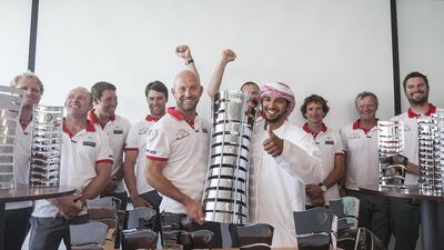 Emirati sailor Adil Khalid, right, Abu Dhabi Ocean Racing sailor Ian Walker, left, and the rest of the Azzam team members pose with the Volvo Ocean Race trophies on Monday back in the UAE. Mona Al Marzooqi / The National / June 29, 2015
