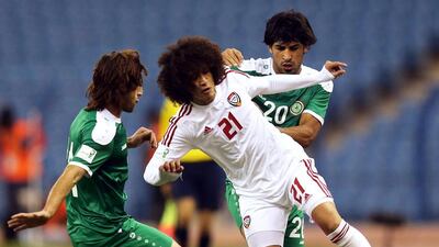 The UAE’s Omar Abdulrahman, centre, has attratced plenty of double coverage during the Gulf Cup of Nations and for good reason. AFP