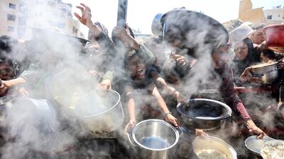 Palestinians receive food at a charity kitchen in Gaza city. AFP