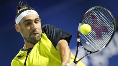 epa05182213 Marcos Baghdatis of Cyprus returns the ball to Feliciano Lopez of Spain during their semi final match of Dubai Duty Free Tennis ATP Championships in Dubai, United Arab Emirates, 26 February 2016. EPA/ALI HAIDER