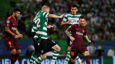Barcelona’s Lionel Messi in action with Sporting’s Jeremy Mathieu. Pedro Nunes / Reuters
