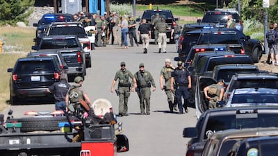 Law enforcement and emergency responders following reports of an ambush shooting attack in Coeur d'Alene, Idaho. AP