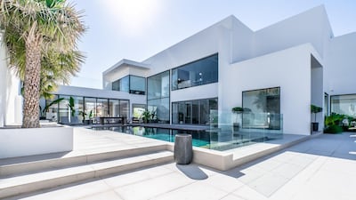 The pool features a wraparound pool deck and adjacent water feature. All photos courtesy LuxuryProperty.com