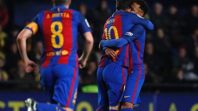 Lionel Messi, centre, celebrates his – and Barcelona’s only – goal with Neymar in the 90th minute, which rescued the draw for the away side. Jose Jordan / AFP