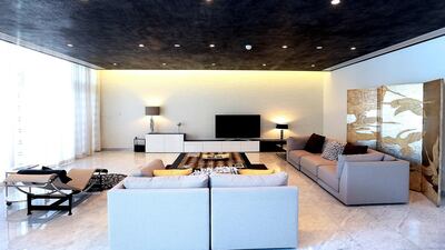 A living room area on the ground floor in a five-bedroom contemporary villa. Satish Kumar / The National