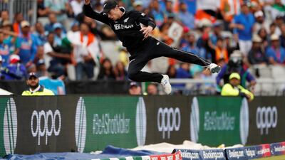 New Zealand's Mitchell Santner makes an acrobatic attempt to stop a MS Dhoni six. Reuters