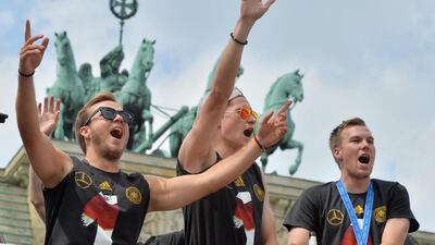 Left to right: Mario Gotze, Julian Draxler and Kevin Grobkreutz wave and cheer to the fans. Goetze scored the winner in the final against Argentina. Hendrik Schmidt / EPA