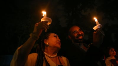 Music industry professionals Reiko Yukawa, Japan, and Boo Mitchell, Memphis, joined mourners who gathered to commemorate the 40th anniversary of the death of singer Elvis Presley at his former home of Graceland. Karen Pulfer Focht / Reuters