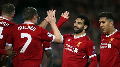 Liverpool's Mohamed Salah celebrates with his teammates after their third goal. Dave Thompson / AP Photo