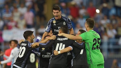The Real Madrid squad celebrate winning the Primera Liga title following the La Liga match against Malaga. Aitor Alcalde / Getty Images