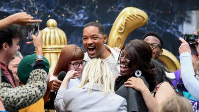 Will Smith attends a magic lamp stunt in London's Leicester Square, to the surprise and delight of fans. Getty Images.
