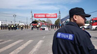 Security guards patrol as police officers block off the road leading to the site of an explosion in Yancheng in China's eastern Jiangsu province. AFP