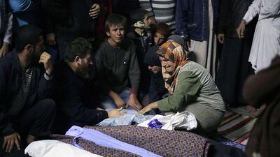 Friends and relatives mourn over the bodies of people that were reportedly killed in airstrikes by Syrian government force in a mosque in the northwestern village of Kansafra, Syria. Mezar Matar / AFP