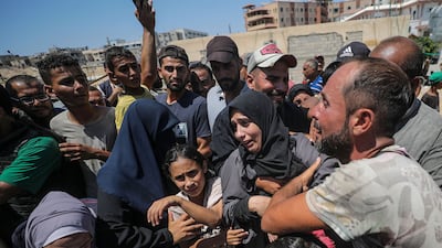 A Palestinian family mourns after their relative was killed following an Israeli air strike in the Al Mawasi area of Khan Younis. EPA